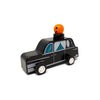 Toy black car with a pumpkin on top against a white background