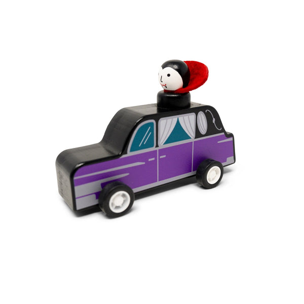 Toy taxi with a Vampire on top against a white background